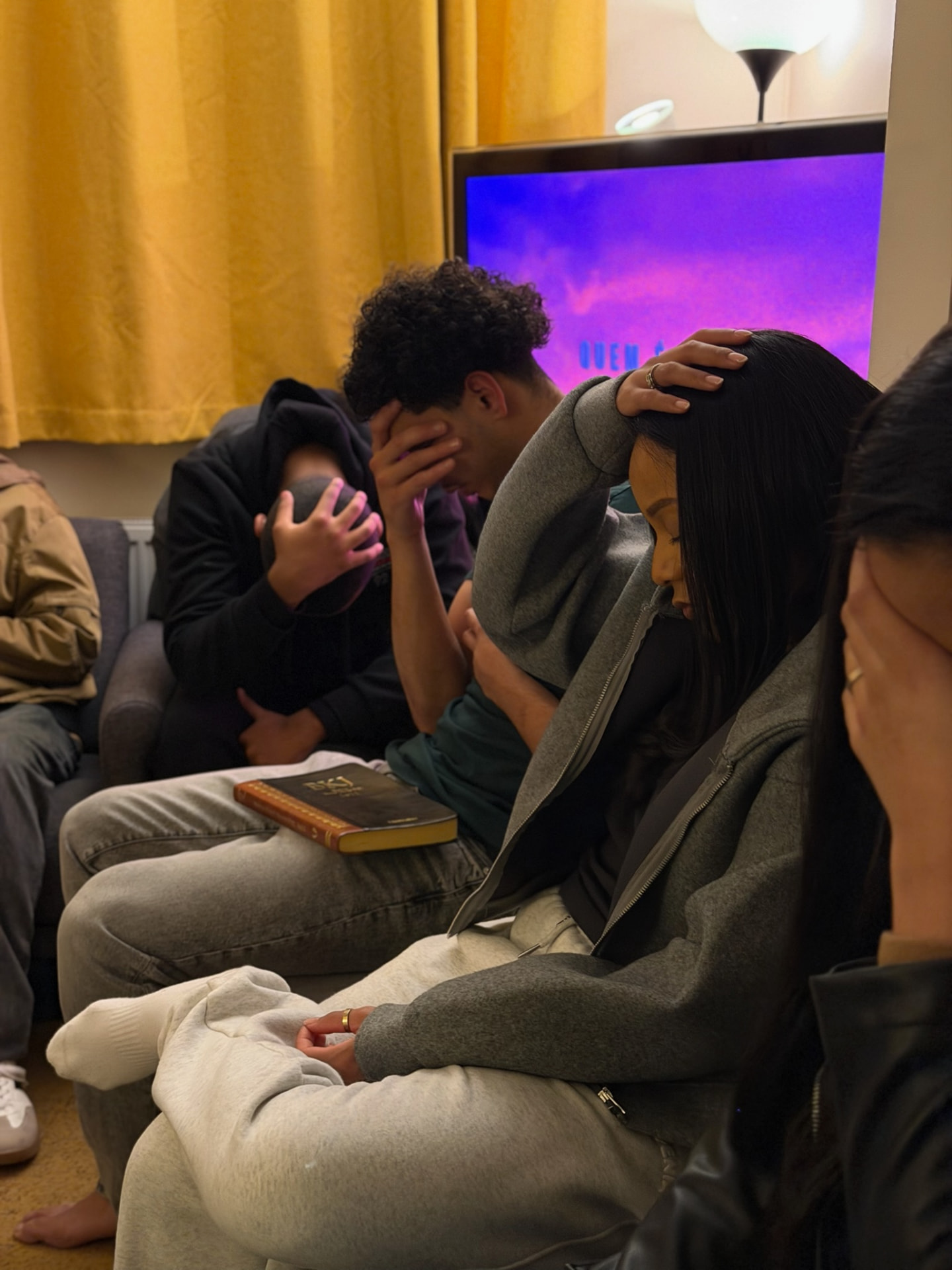 Young people in prayer at AGGF UK