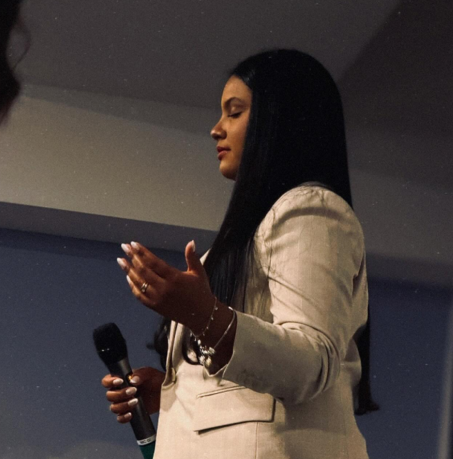A worship leader in song at AGGF UK